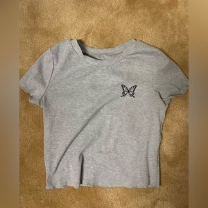 Light grey shirt with butterfly.